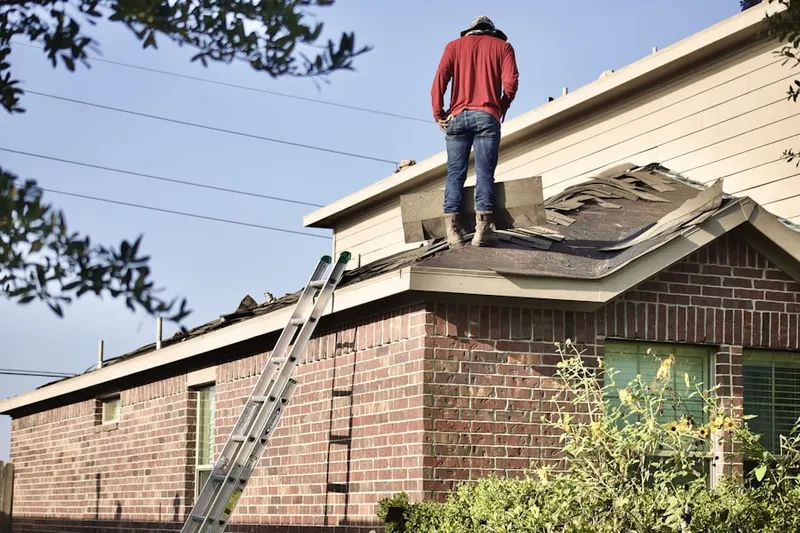 Professional roofer working on a residential roof in Cherry Creek Country Club